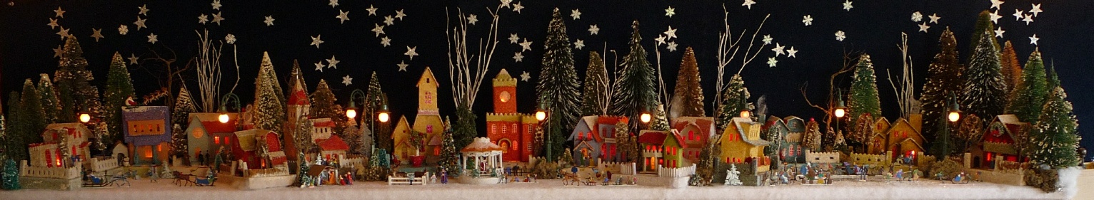Antique Christmas cardboard house putz (village) on fireplace mantel at night (200K)